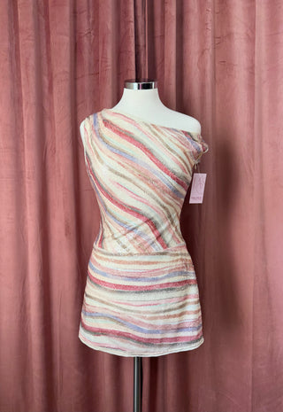 Mannequin wearing a colorful striped dress against a pink curtain background