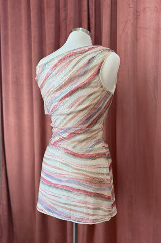 Multicolored striped dress on a mannequin against a pink curtain background